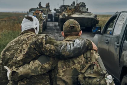 Soldier supporting injured Ukrainian soldier